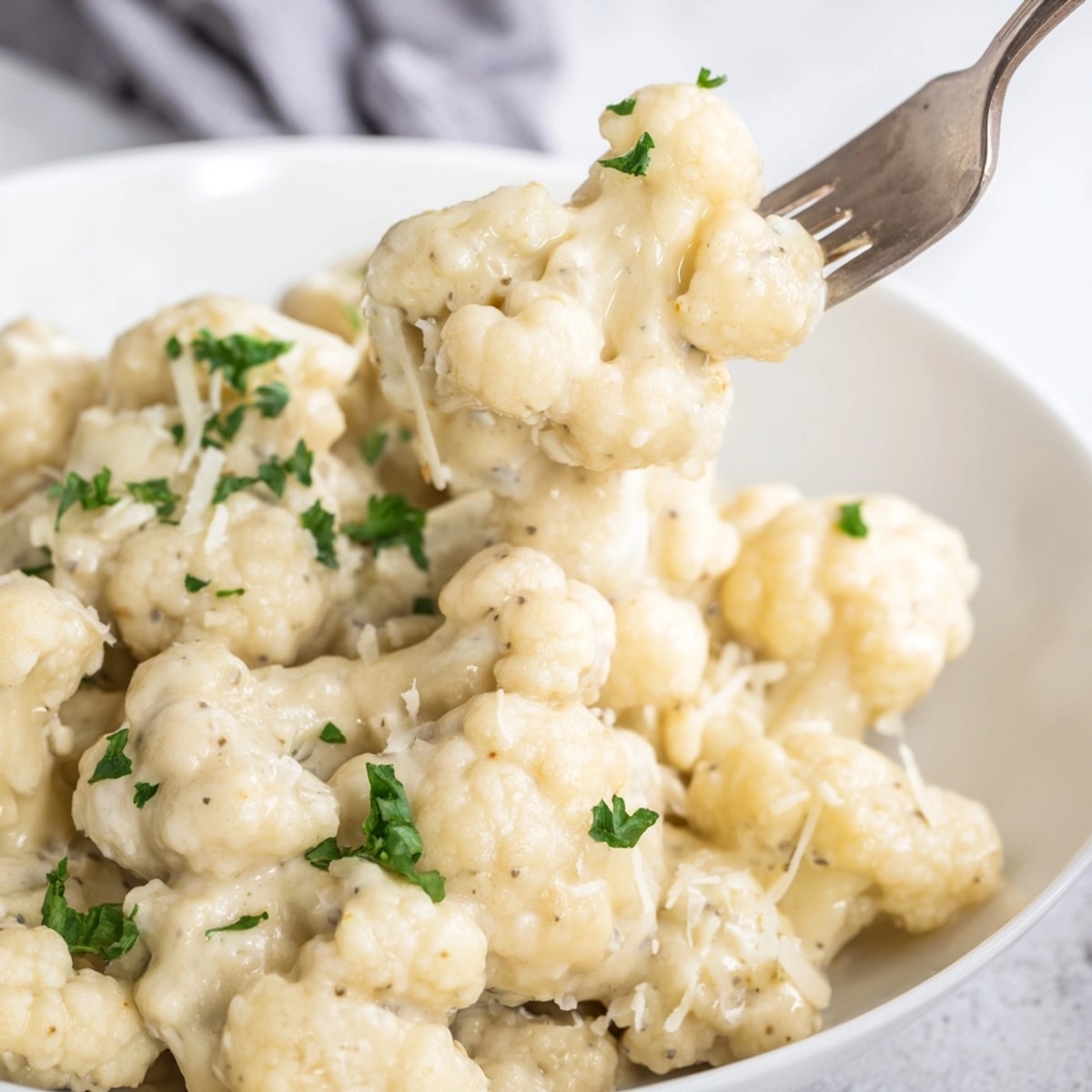 Creamy Alfredo Cauliflower Garlic Skillet, simmering invitingly with fresh parsley garnish.