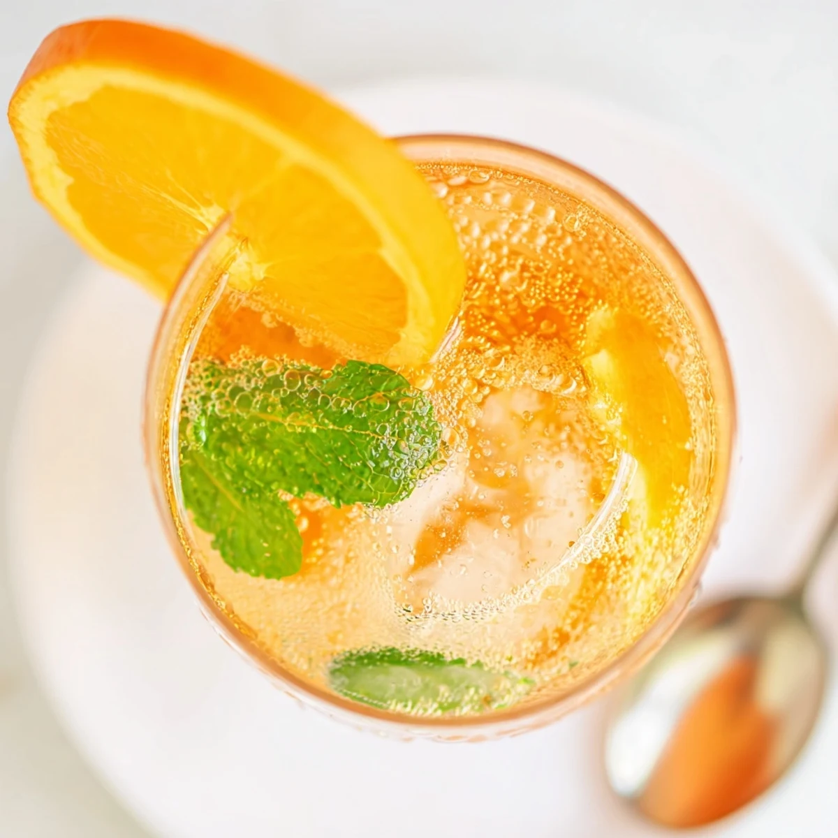 Zesty homemade probiotic soda mocktail, bursting with citrus and mint flavors.  