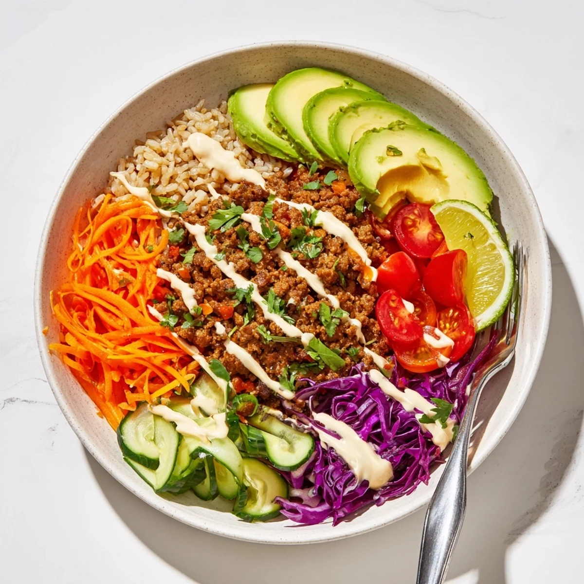 Satisfying plant-based meat bowl drizzled with spicy mayo and vibrant toppings.  