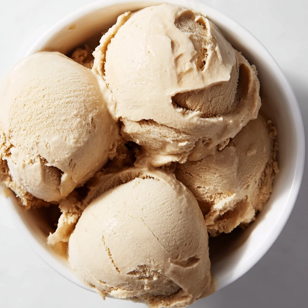 Enjoy a bowl of homemade peanut butter banana ice cream, a simple sweet treat.