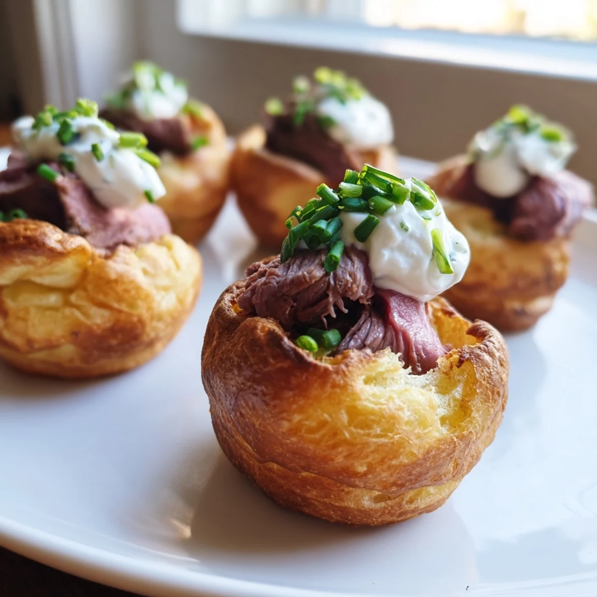 Golden-brown Express Holiday Yorkshire Pudding Bites, filled with tender roast beef and creamy horseradish.