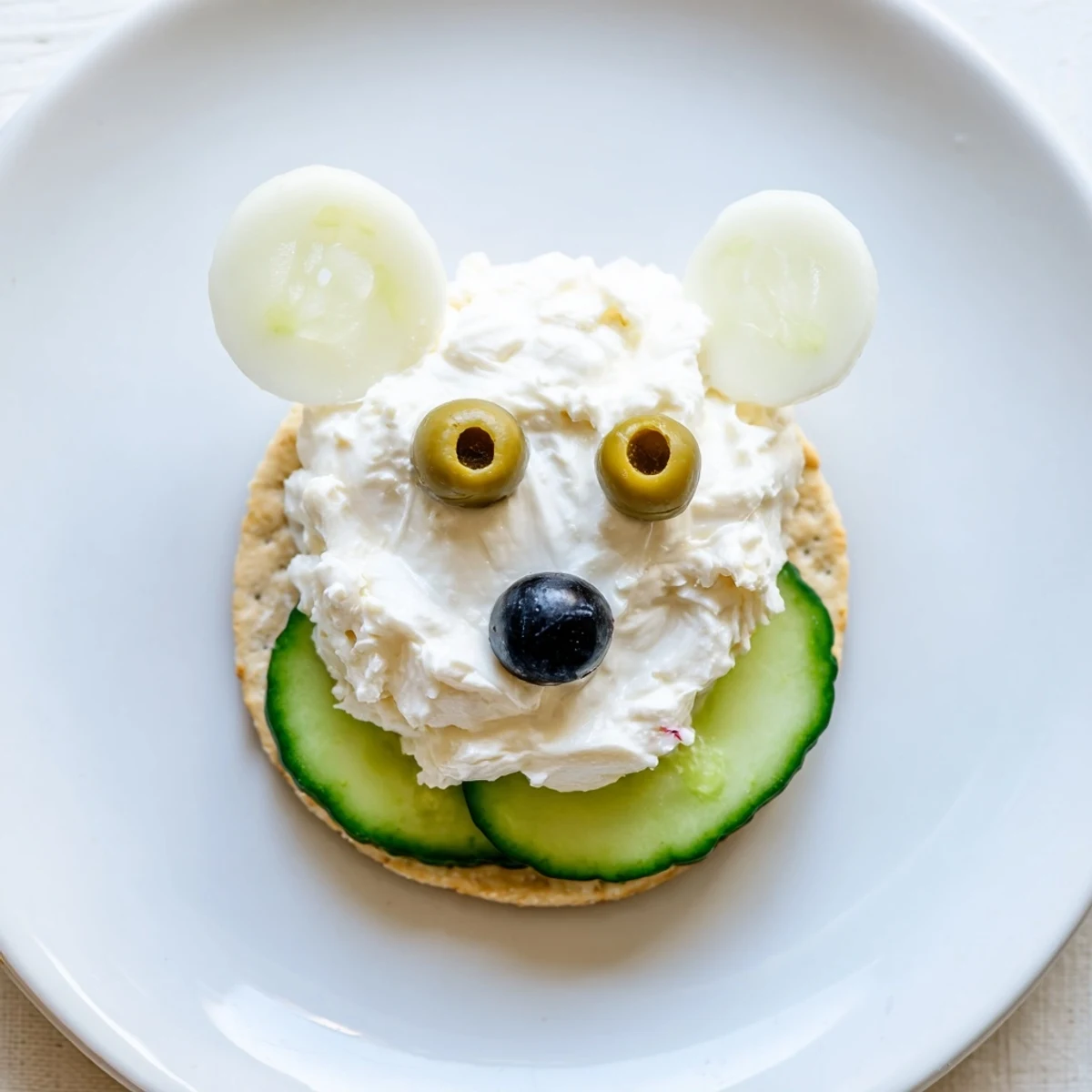 Crisp crackers topped with cream cheese, cucumber iceberg, and delightful Polar Bear Iceberg Cracker Stacks.
