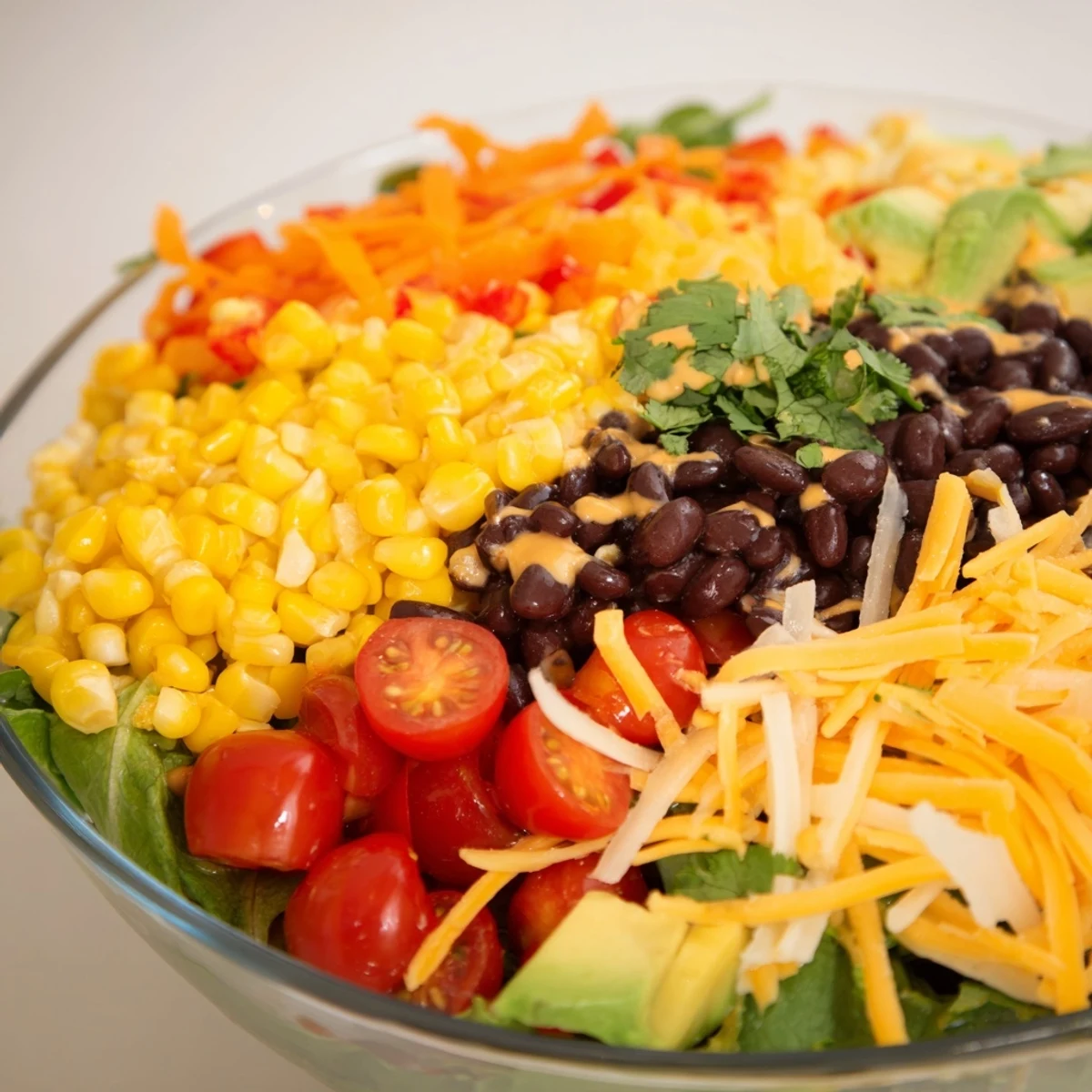 Southwest Sunset Palette salad features vibrant layers of vegetables and spicy chili cheese for a flavorful meal.