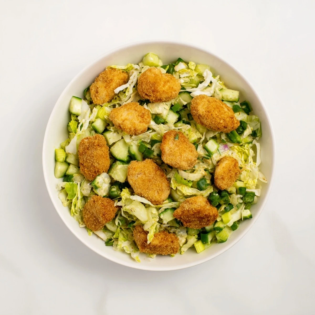 Enjoy a satisfying bite of the crunchy Green Goddess Nugget Salad with golden, crispy nuggets.