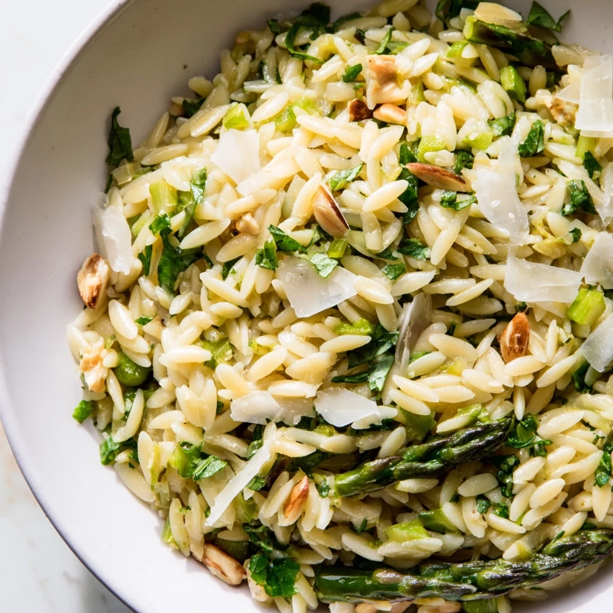 Shaved asparagus ribbons and tender orzo tossed in a bright lemon vinaigrette, topped with grated Parmesan.