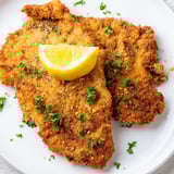 Thin, breaded German schnitzel cutlets, beautifully browned and piled high, perfect with potato salad.