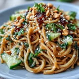 Vibrantly topped cold peanut sesame noodles featuring crunchy peanuts, perfect for summer.