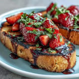 Bright strawberries, herby basil, and sweet glaze crown toasted sourdough slices.