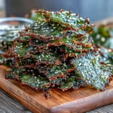 Golden-brown seaweed snack chips, a healthy vegan snack, sprinkled with sesame.