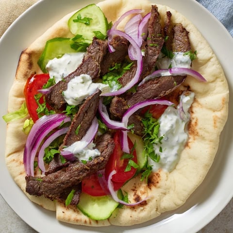 A close-up of delicious Beef Shawarma Wraps, filled with tender meat and creamy sauce.
