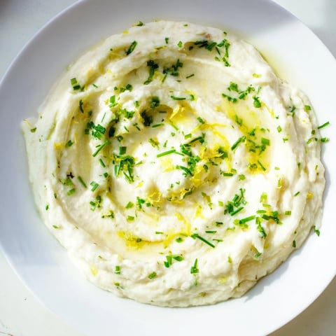 Creamy Cauliflower Mash with Garlic & Lemon Herb, ready to serve with fresh herbs, a vibrant side.