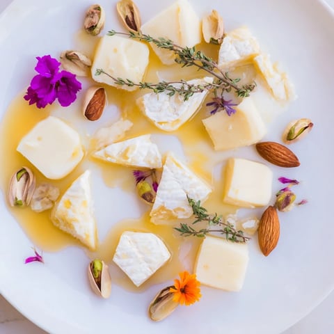 Honeycomb Hexagon Maze, visually appealing cheese platter with honey drizzle, almonds, and pistachios.