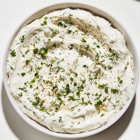 Creamy Greek Yogurt Ranch Dip, studded with fresh herbs, ready for carrots and celery.