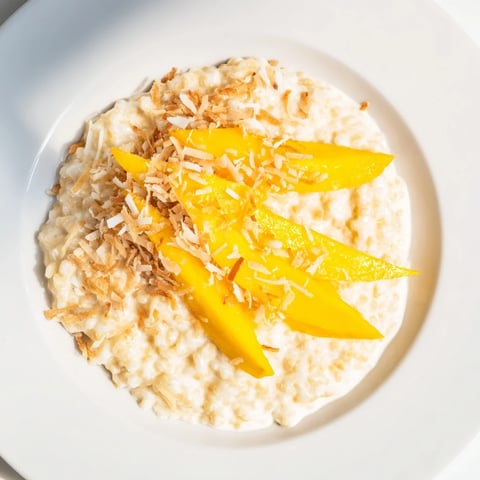 Creamy toasted coconut rice pudding, warm and comforting, topped with golden toasted coconut flakes.