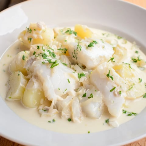Steamy bowl of Icelandic Fish Stew, showing chunky potatoes, flaky fish, and fresh herbs.