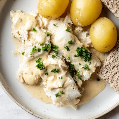 Golden, flaky Norwegian Lutefisk seasoned with salt and paired with creamy mustard sauce.