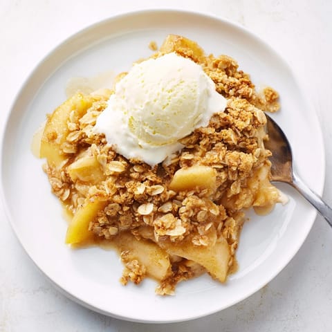 Homemade Apple Crisp: View of the warm dessert, a buttery oat topping, and soft baked apples.