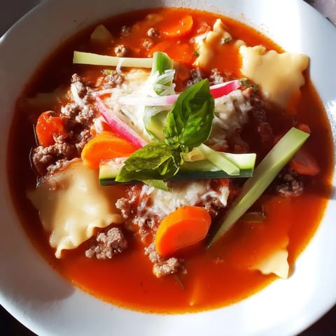 Warm and comforting Lasagne Soup, garnished with tangy pickled vegetables for freshness.  