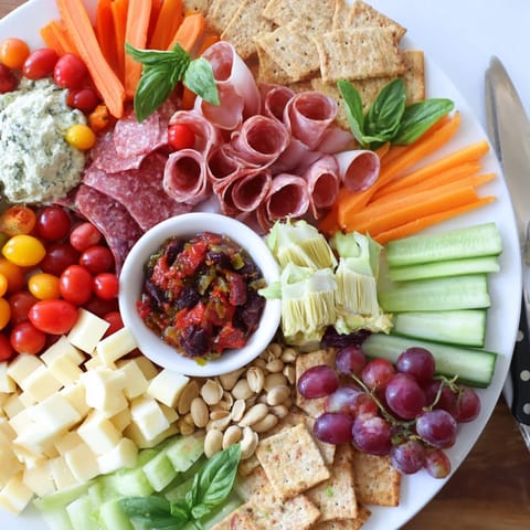 Charcuterie-style Girl Dinner Platter filled with creamy dips, nuts, and fresh ingredients.  