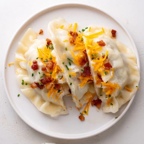 Golden, pan-fried Loaded Baked Potato Soup Dumplings; crispy edges reveal a creamy, savory filling.