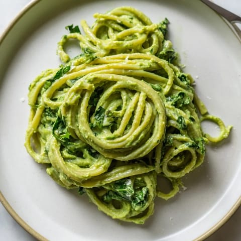 Freshly tossed green goddess pasta with herbs and Parmesan, ready for dinner.