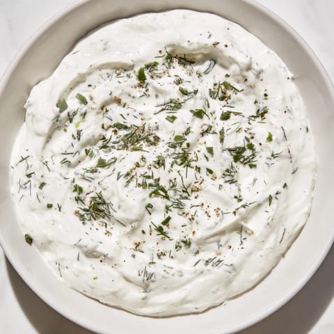 A close-up shot of the vibrant Greek Yogurt Ranch Dip, perfect for dipping veggies.