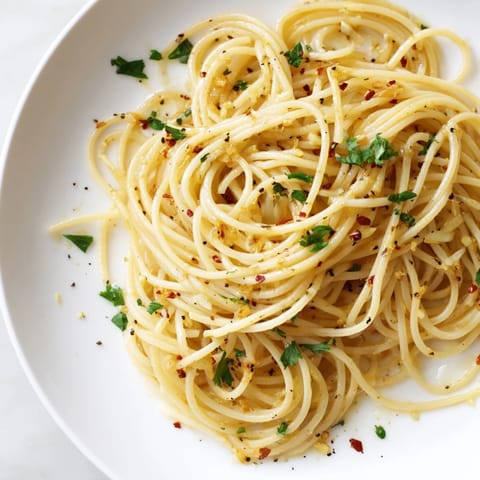 Close-up of golden garlic-infused Aglio e Olio Express Pasta, perfect for a quick and savory Italian dinner.