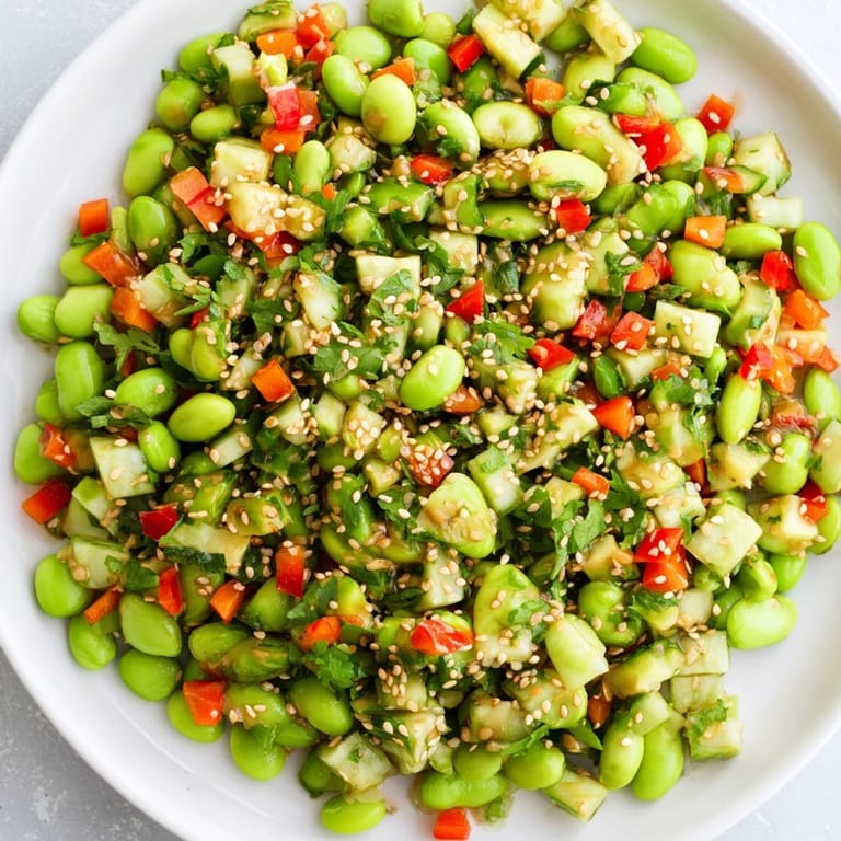 Chilled edamame salad featuring colorful vegetables and a delicious sesame dressing atop it.