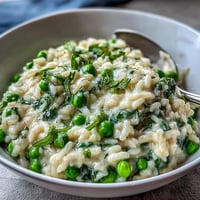 Creamy Spring Pea Risotto with fresh mint, Parmesan, and lemon zest in a cozy bowl.